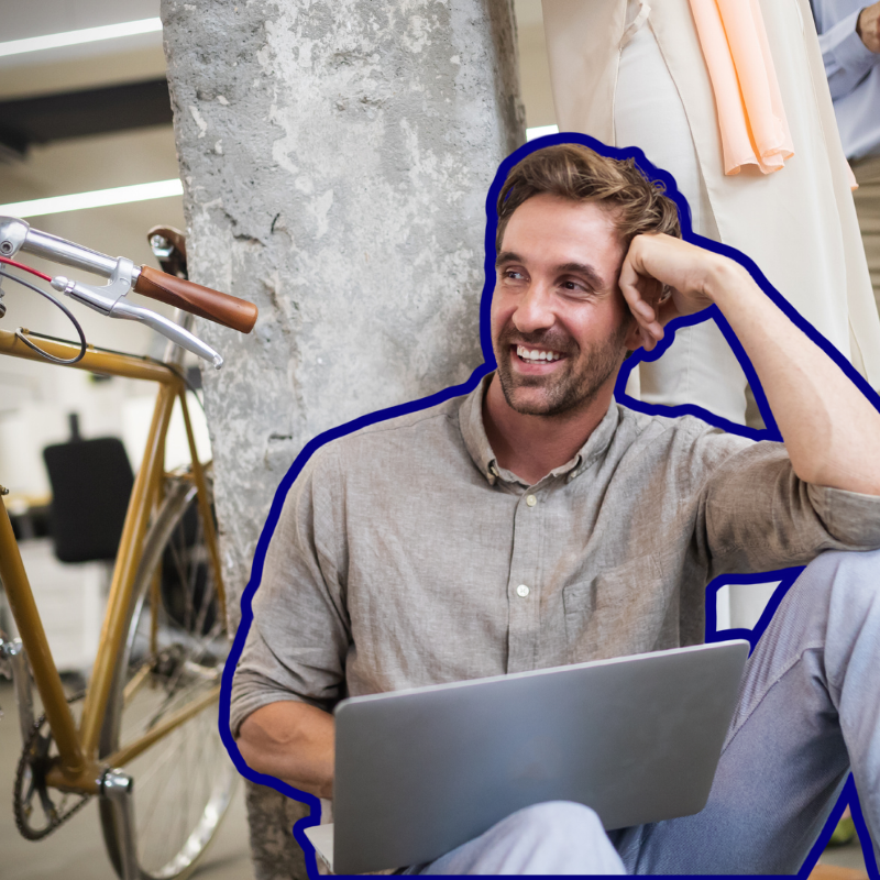 Man sitting with bike and laptop